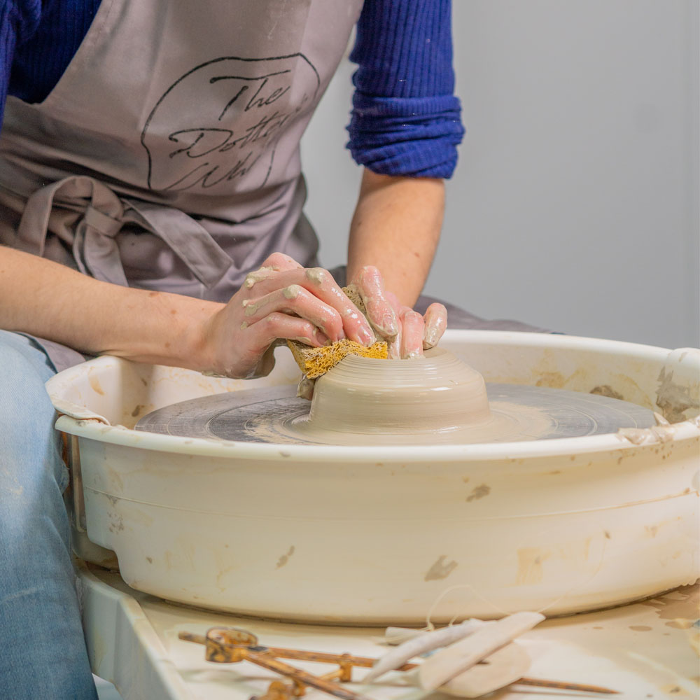 Pulling out the clay on the wheel